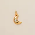 Detail shot of a golden stainless steel crescent moon pendant with a sparkling crystal sun. - Crescent Sun Radiance Pendant