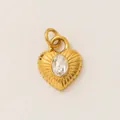 Macro detail view of a vintage gold heart pendant with a central oval crystal inlay - Radiant Texture Heart Crystal Pendant