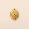 Macro detail of golden stainless steel shield pendant with sunburst evil eye design - Evil Eye Shield Pendant