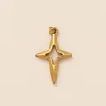 Detailed macro shot of a gold-plated four-pointed star pendant with center cutout - Four-pointed Star Hollow Pendant