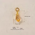 Détail d'un pendentif en cristal ambre facetté avec anneau en cuivre pour bijoux DIY. - Pendentif Cristal Jaune Pâle