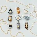Collection of nine cute ceramic animal pendants with golden heart detail accents - Penguin Shape Pendant / Colorful
