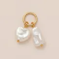 Detail of gold ring charm featuring a heart-shaped and a baroque pearl pendant - Heart Double Pearl Pendant / Gold/White