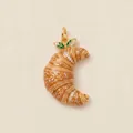Detailed macro view of gold croissant pendant with sparkling stones and leaves - Croissant Pendant