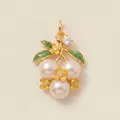 Close-up of floral pearl pendant with gold finish and enamel flower accents. - Pearl Grape Pendant