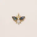 Detailed view of a gold bee pendant with labradonite wings and white crystals. - Bee Pendant
