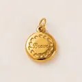 Detailed close-up of a gold stainless steel pendant with 'Brave' and heart pattern - Brave Style