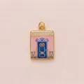 Detail view of a vintage rectangular enamel pendant featuring a pink villa and blue door. - Pink Door Frame House Pendant Only