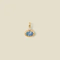 Macro detail of a 18K gold-plated oval pendant featuring a faceted light blue gemstone - Light Blue Oval Gemstone / March Style Gold