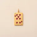 Close-up of golden stainless steel Seven of Hearts poker card pendant with red details - Heart 7 Poker Card Pendant / Gold
