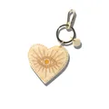 Creative acrylic heart-shaped bag charm featuring golden sunburst eye design and marble texture - Heart Sun Style