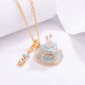 Close-up of a blue heart-shaped cake necklace pendant with a miniature rabbit - Necklace / Blue