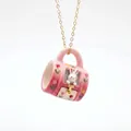 Detailed macro view of a cute pink ceramic mug pendant necklace featuring a white rabbit - Pink Bunny Mug Style