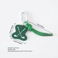 Sporty golf themed bag charm featuring a green alloy pendant and white carabiner clip - Golf Club Style Pendant