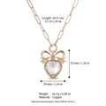 Elegante collar con colgante de corazón, lazo dorado y cadena de clip en cobre - Collar de Relicario Vacío de Corazón y Lazo de Vidrio