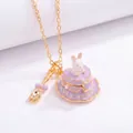 Macro shot of a purple enamel rabbit cake pendant necklace with mini golden spoon charm - Necklace / Purple