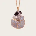 Detailed close-up of a cute dog peeking out from a miniature blue suitcase pendant - Light Blue Suitcase Puppy Style