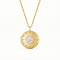 Macro view of vintage gold round locket pendant featuring a starburst and crystal center. - Round Rhinestone Locket