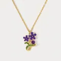 Detailed close-up of a purple enamel flower pendant on a dainty gold chain necklace. - February Violet