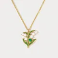 Detail view of gold-tone lily of the valley enamel pendant with green crystal accent - May Lily