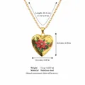 Close-up showing dimensions of gold heart locket necklace with red poinsettia flower - December Birth Flower Locket Necklace / Gold