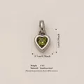 Heart-shaped 316 stainless steel birthstone pendant featuring a vibrant green gemstone detail - August Birthstone Pendant / Steel