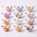 Detailed view of twelve different cartoon animal-shaped mini teacup pendants in a grid. - Pink Cat (Pendant Only (Without Chain))