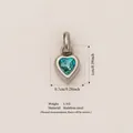 Heart-shaped stainless steel pendant featuring a blue December birthstone gemstone - December Birthstone Pendant / Steel