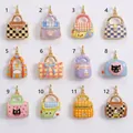 Detailed view of twelve colorful enamel handbag charms featuring diverse plaid and cartoon patterns - Black Brown Checkerboard Handbag Pendant