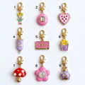 Collection of nine vintage-style enamel charms with gold star clasps on white background - Cartoon Girl Charm
