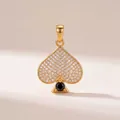 Close-up detail of a vintage gold spade pendant featuring pavé crystals and a black stone accent - Spade Card Pendant