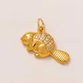Macro view of a golden animal pendant with inlaid sparkling white crystals for DIY jewelry - Beaver Charm