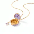Detail view of an open purple enamel heart locket necklace with floral interior pattern - February Violet / February Violet Purple