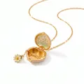 Detailed view of gold enamel heart locket necklace with delicate daisy flower charm. - April Daisy / April Daisy Light Apricot