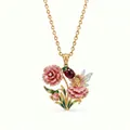 Detailed close-up of an enamel flower fairy pendant necklace with pink carnation and gem - January Pink Carnation Necklace