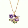Close-up of fairy and flower enamel pendant with purple gemstone and tiny crystals. - February Violet Necklace