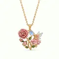 Detailed macro view of an exquisite enamel fairy and rose pendant necklace in gold finish - June Pink Rose Necklace