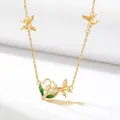 Detailed view of elegant gold-plated necklace featuring butterfly and lily of the valley - May