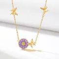 Gold-toned necklace featuring a purple daisy pendant and delicate butterfly accents. - September