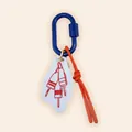Close-up of nautical buoy bag charm featuring blue carabiner and red braided rope - Navy Nautical Buoy Style