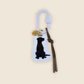 Detail view of a retro style bag charm featuring a black Labrador silhouette on a white tag - Milk Blue Black Labrador Style