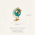 Detailed view of a gold-plated copper globe charm with blue enamel for DIY jewelry - Mini Globe