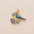 Detailed macro shot of a colorful enamel blue tit bird pendant charm for DIY jewelry craft - Bird Berry Pendant