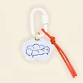 Detail view of a minimalist bag charm with a blue sofa sketch and vibrant red cord - Cloud Sofa (Blue Line) / Red/White/Gold/Blue