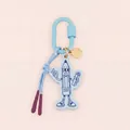 Detailed macro view of a light blue cartoon pencil acrylic bag charm with carabiner. - Cartoon Pencil Figure
