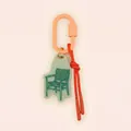 Detail of chair pendant keychain with orange carabiner and red cord accent. - Rattan Chair / Light Green/Orange/Bright Red