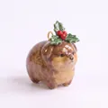Close-up of a brown ceramic dog pendant with festive holly leaf and red berry decoration - Holly Berry Dog Pendant (MQPK262714KI)