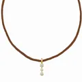 Detailed view of three-diamond gold pendant on a brown woven cord necklace - Triple Round Rhinestone Style / Brown