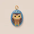 Detailed macro view of the handcrafted enamel owl pendant with crescent moon pattern. - Owl Oval Pendant