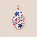 Detail of hand-painted enamel oval pendant featuring vibrant red and blue star patterns - Star Oval Pendant